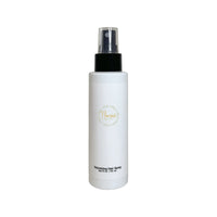 Flourea Volumizing Hair Spray 4 fl oz white bottle with black pump dispenser and clear cap against a plain white background, showing gold logo and labeling.